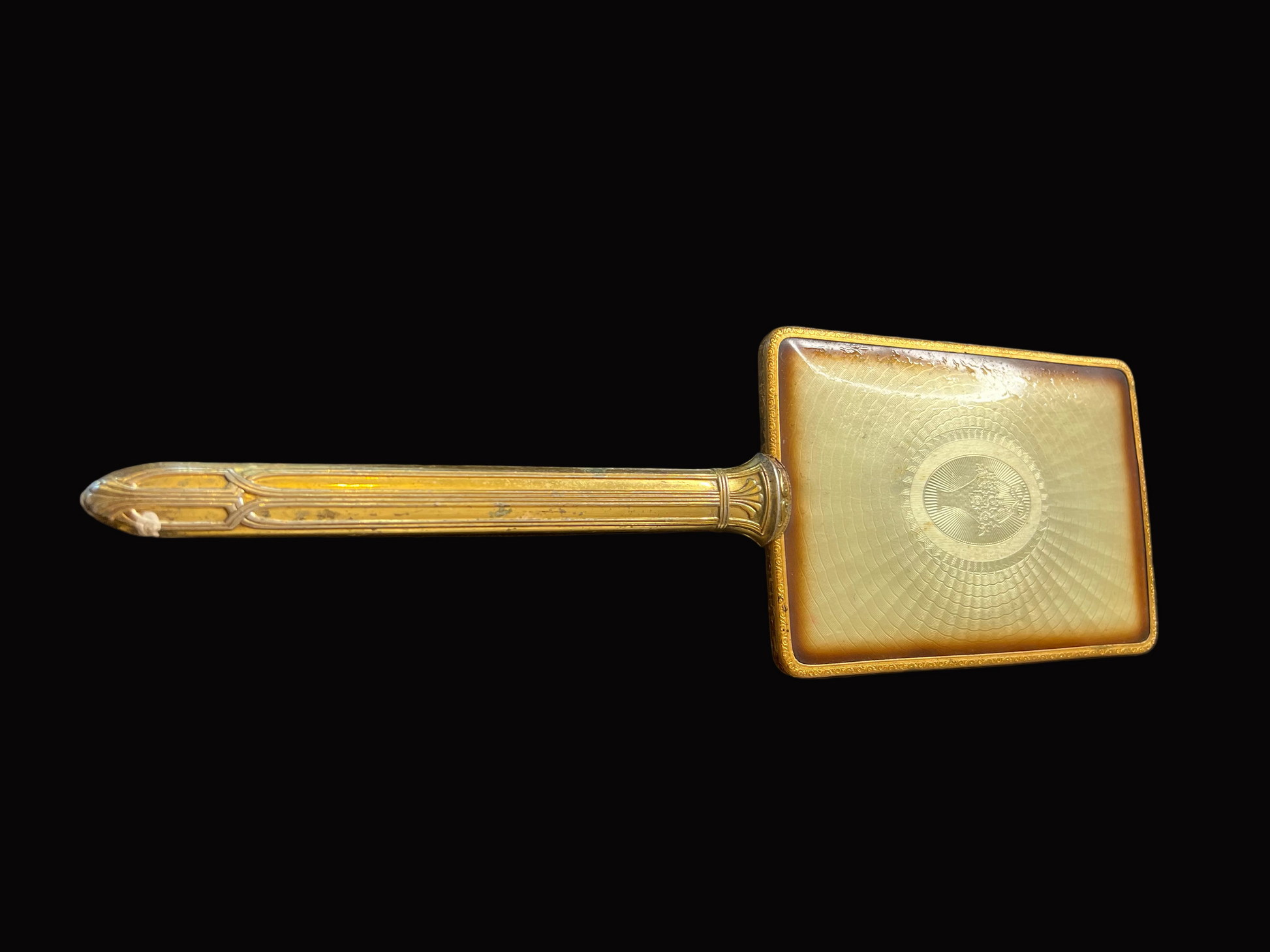 Decorative gold object on a textured black surface